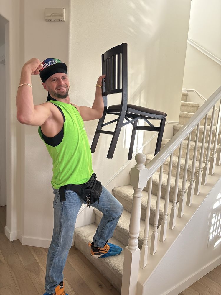 Pure Movers employee carrying chair upstairs during residential move
