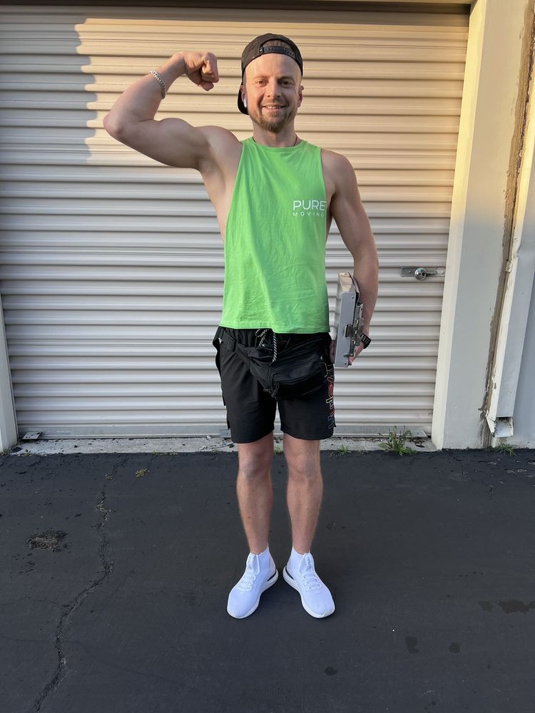 Pure Movers employee standing outside storage unit during moving service