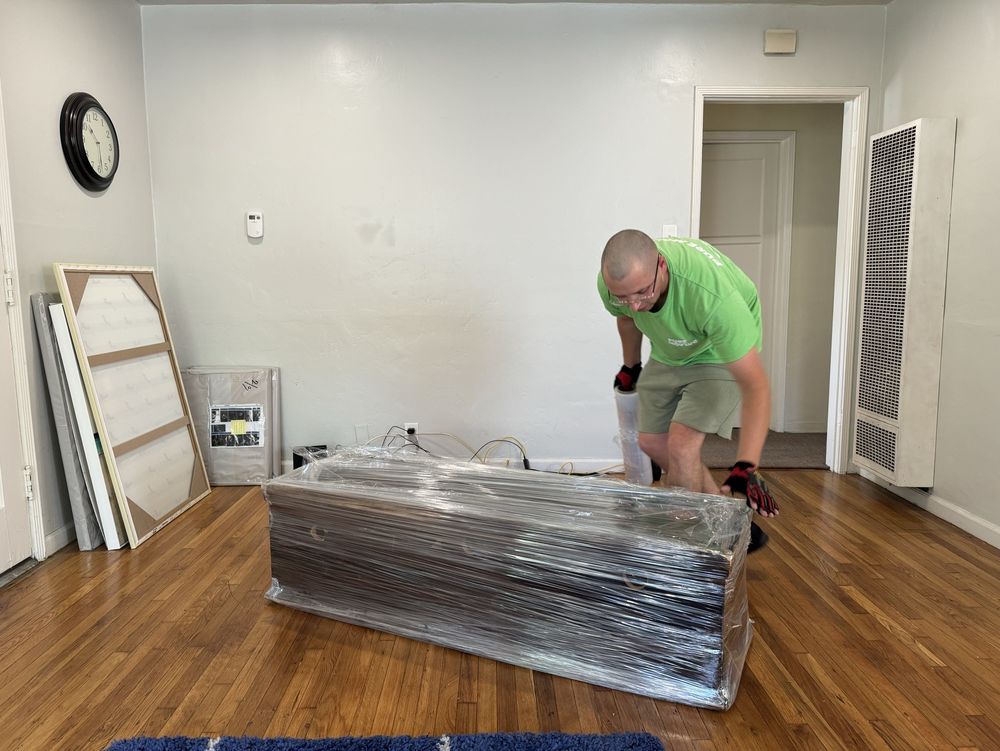 Pure Movers employee wrapping furniture for safe residential move