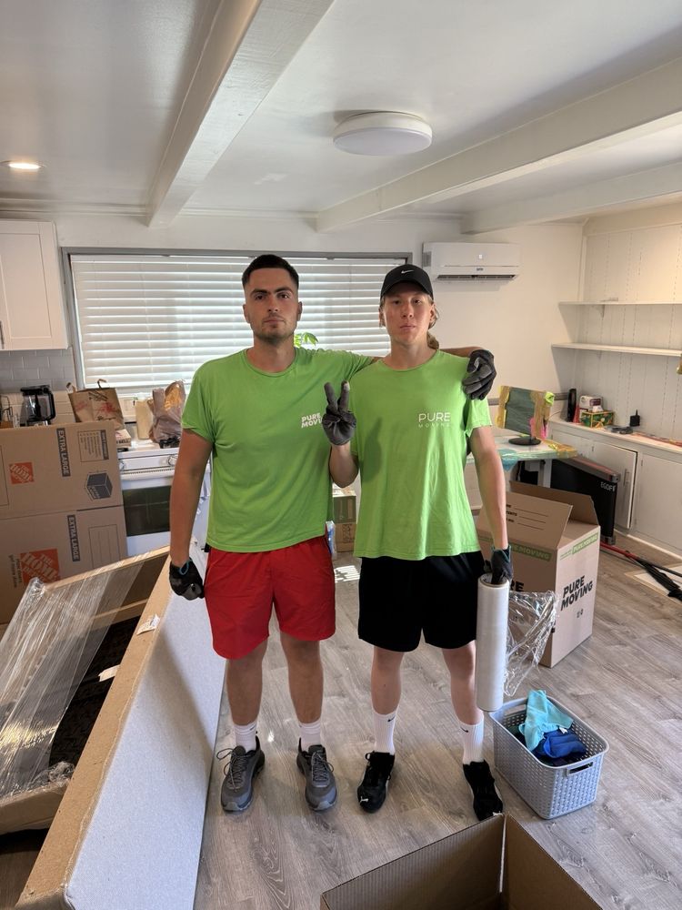 Pure Movers crew standing inside home during packing and moving service
