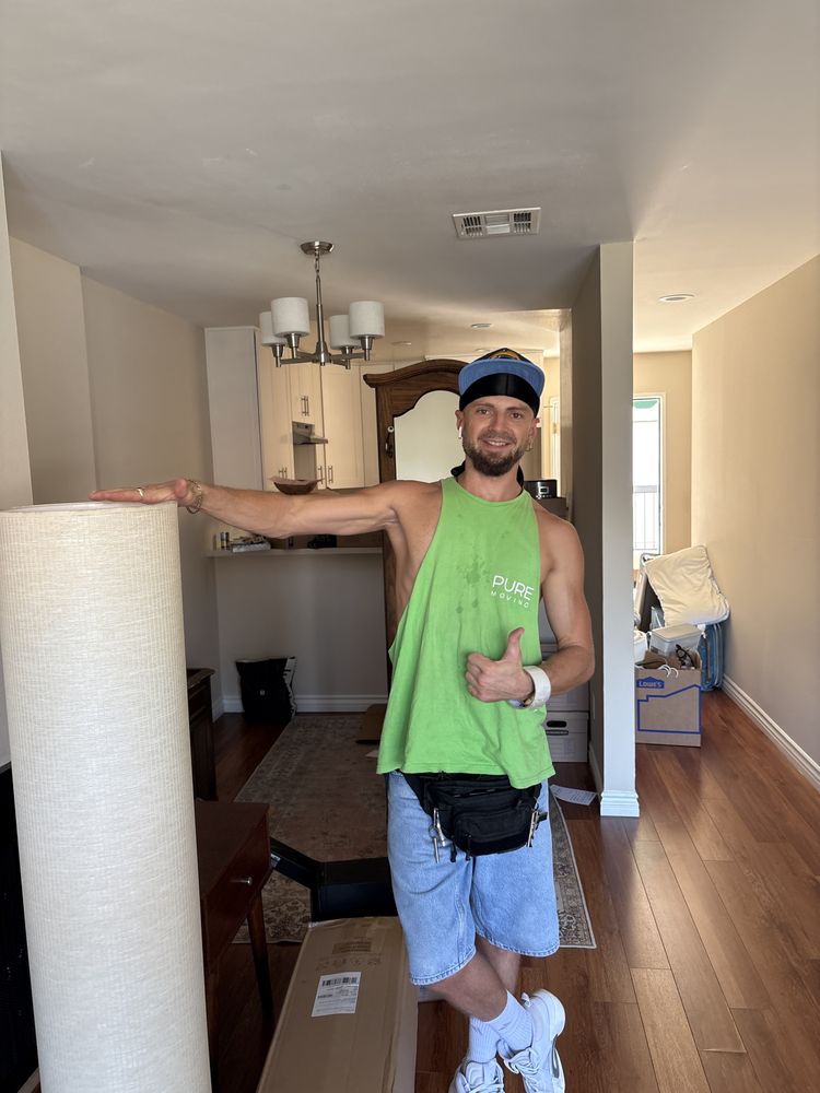 Full service mover carrying protected household items during move