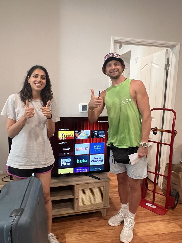 Customer posing with Pure Moving mover after successful move