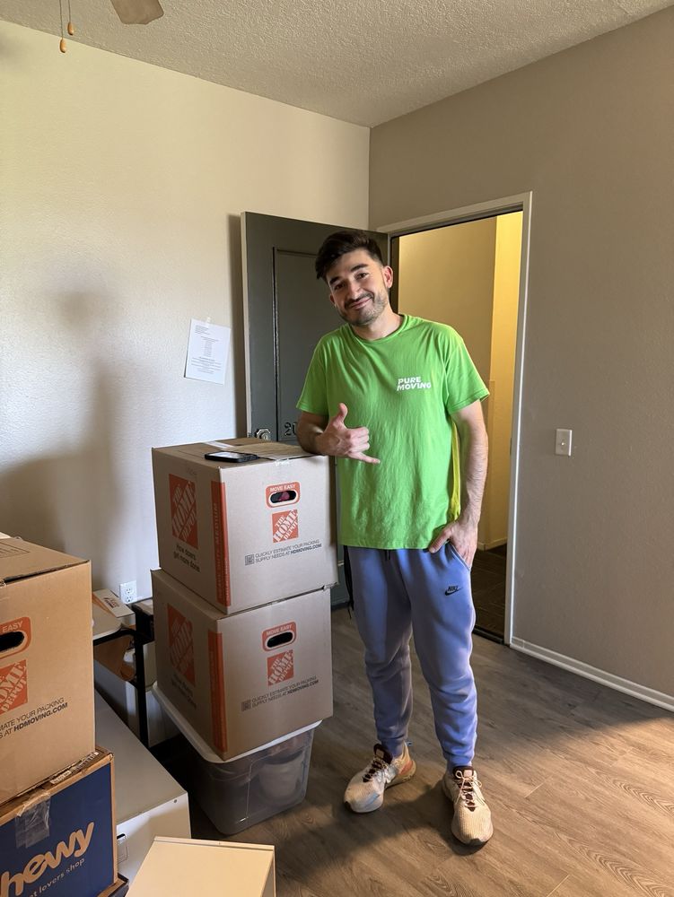Packing services mover handling labeled fragile moving boxes