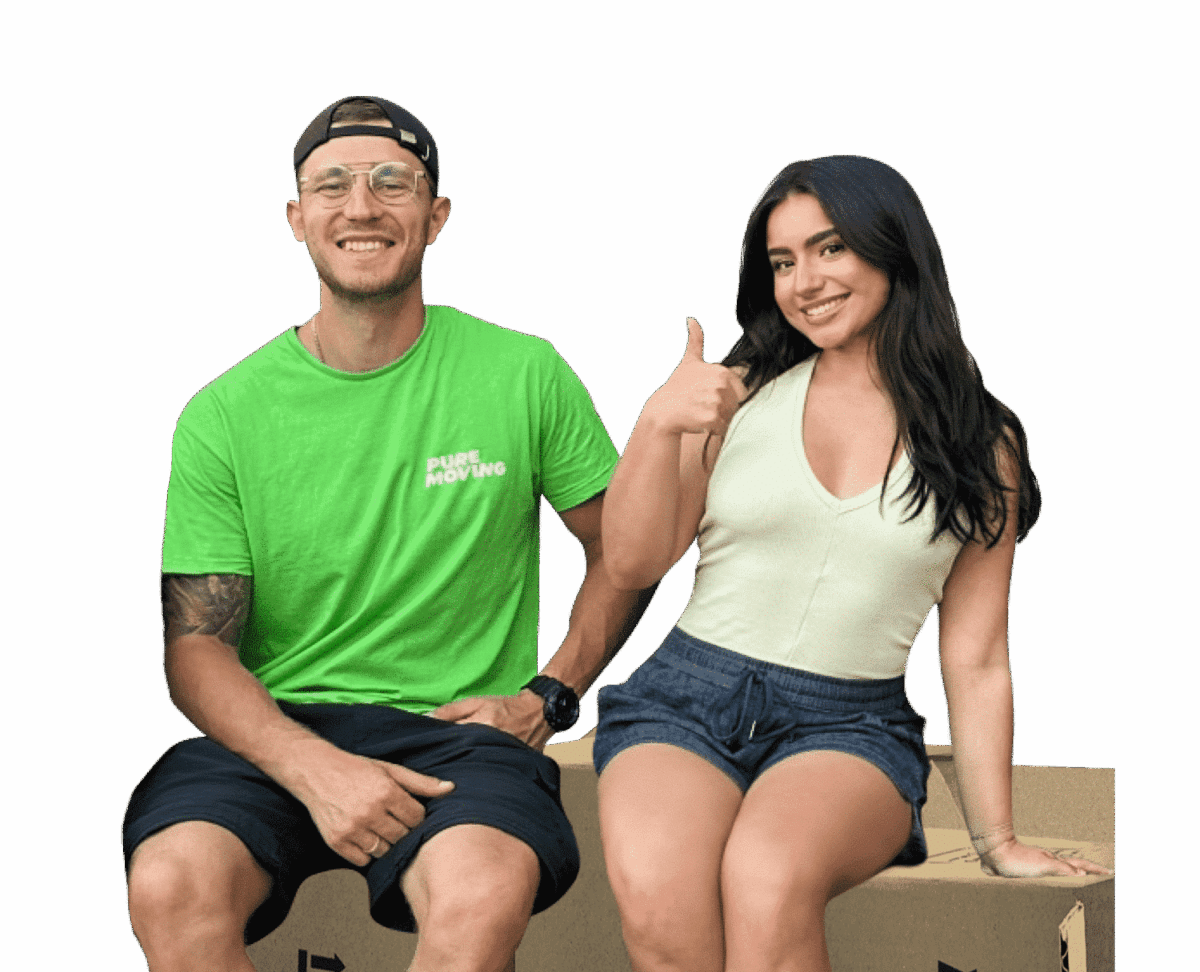A man in a green shirt and glasses sits beside a woman in a white top and shorts. She gives a thumbs-up gesture while both smile. Trusted Long Distance Moving Company in the Bay Area