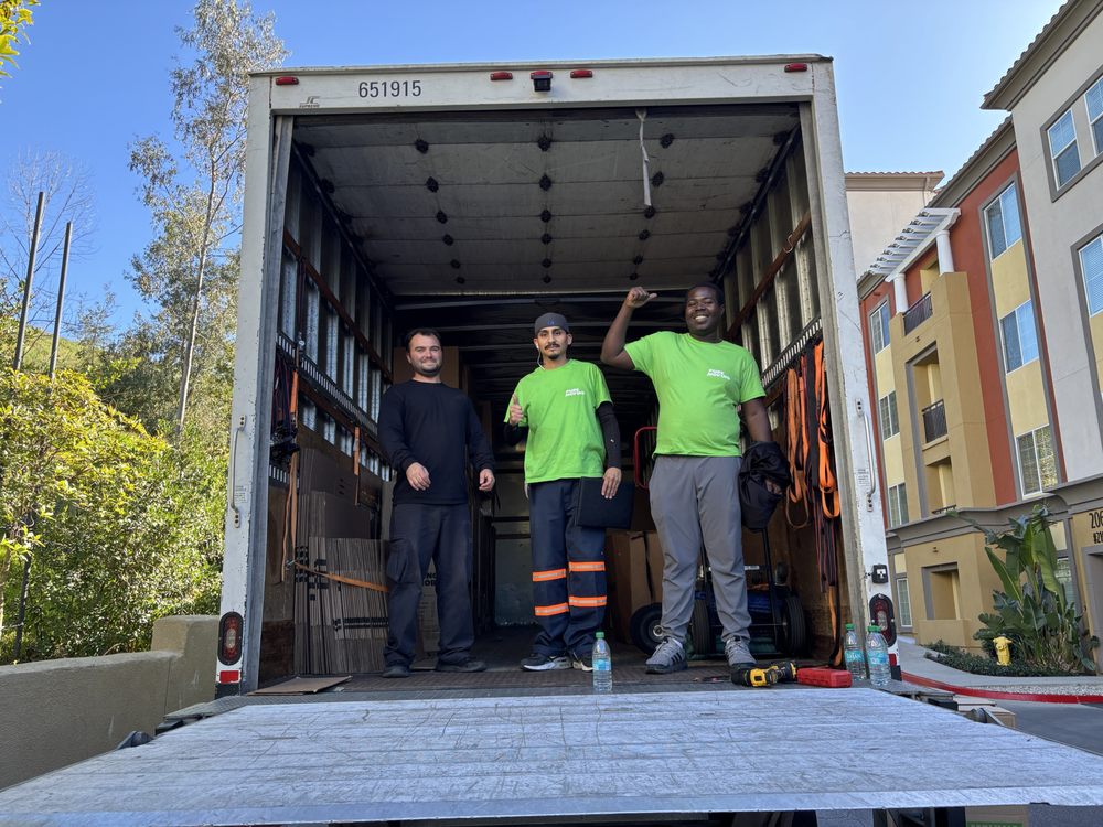 Pure Moving crew standing inside moving truck during apartment relocation job