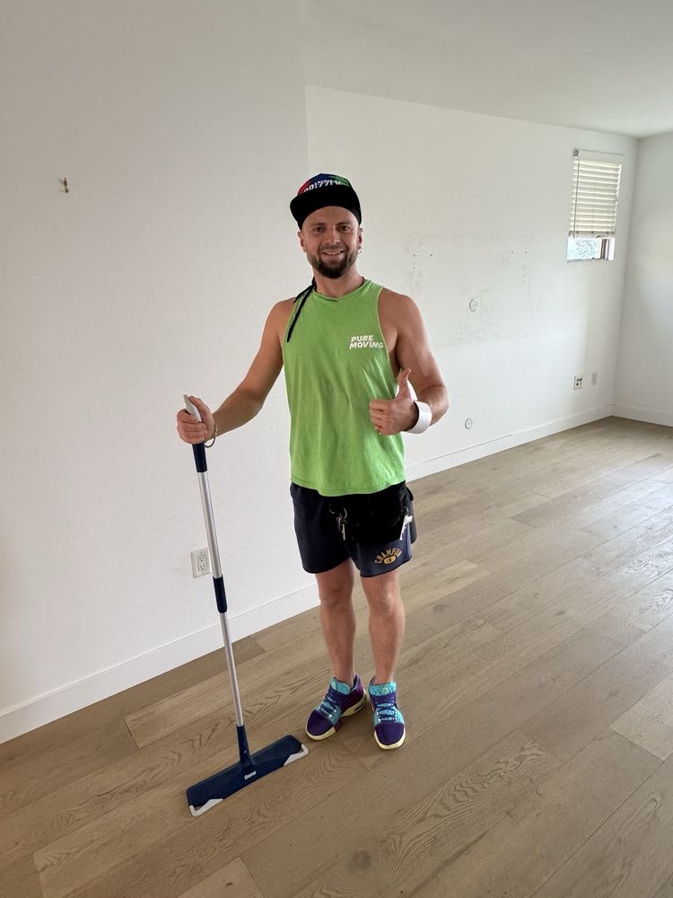 Professional mover cleaning empty room floor after residential move-out